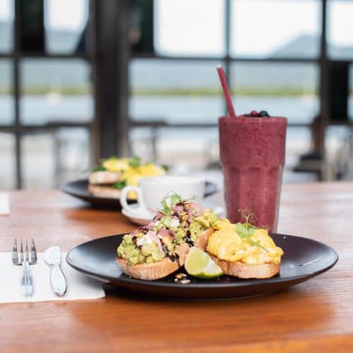 Wharf One Cafe - Gallery avocado eggs toast smoothie view of water